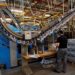 Men wearing protective face masks work at a printing press amid the coronavirus disease (COVID-19) outbreak in Madrid, Spain, June 13, 2020.